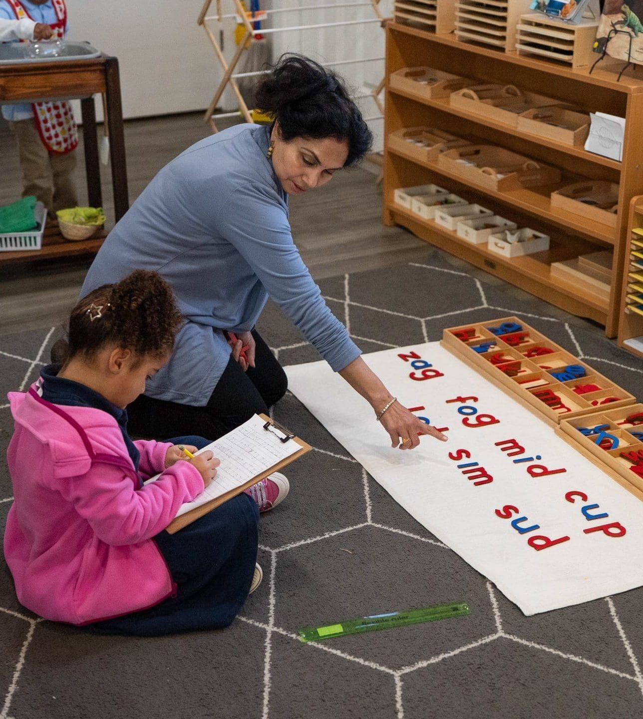 Lower El student writing with a pencil