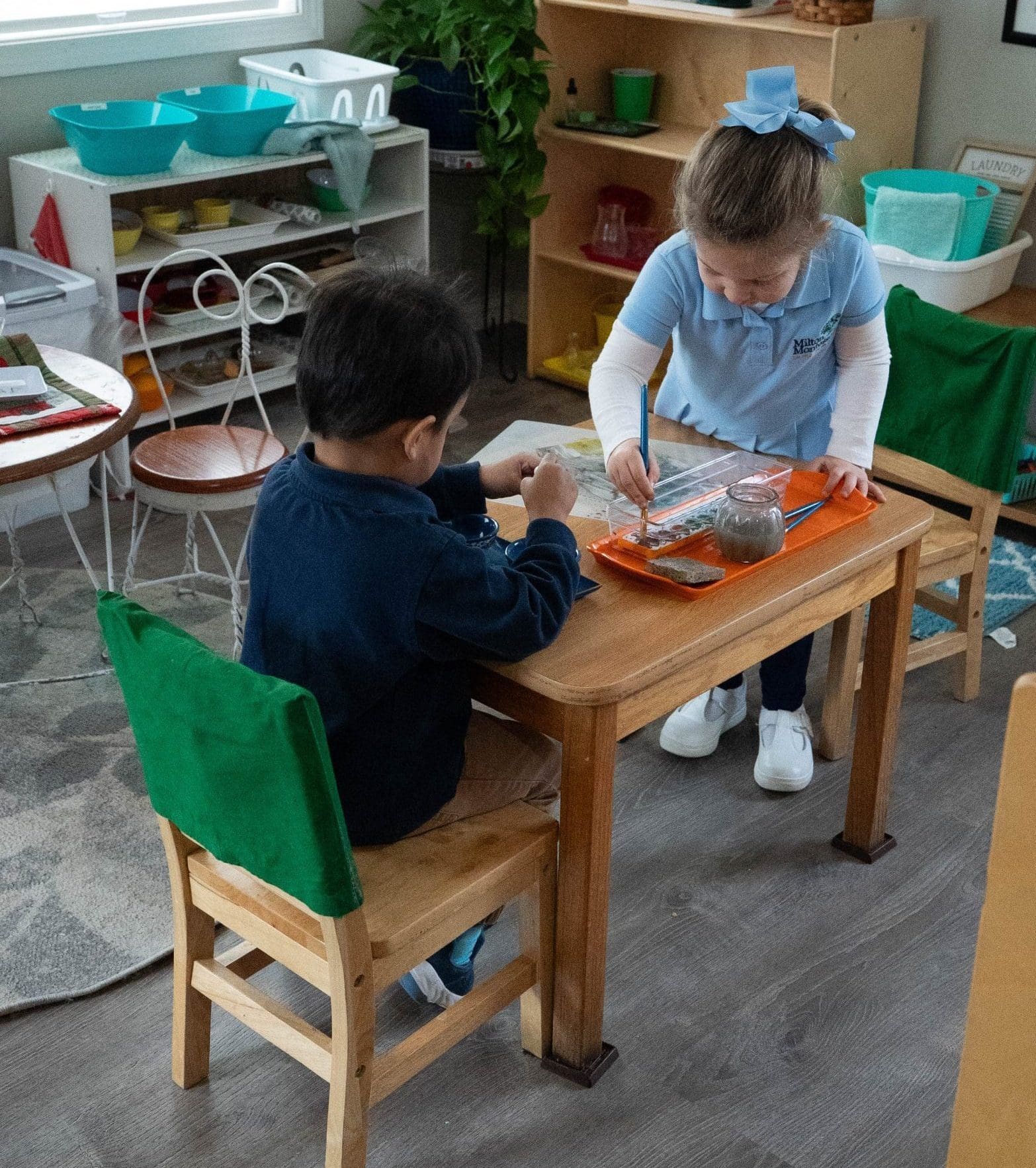 Preschool girl works with Montessori bead chains